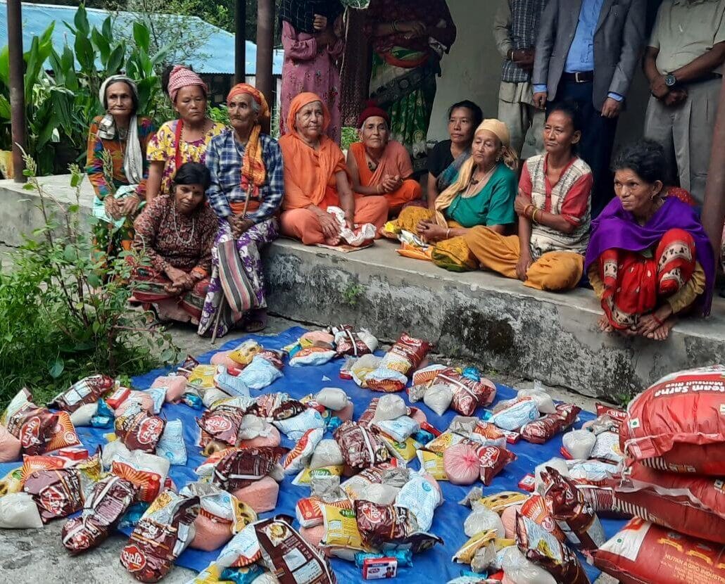 Distributing food materials to the respected elders